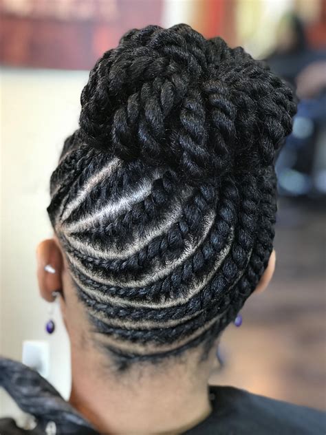 Try a double-sided pull-through braid with a rolled-up bun for simple updo hairstyles. . Natural braided updo